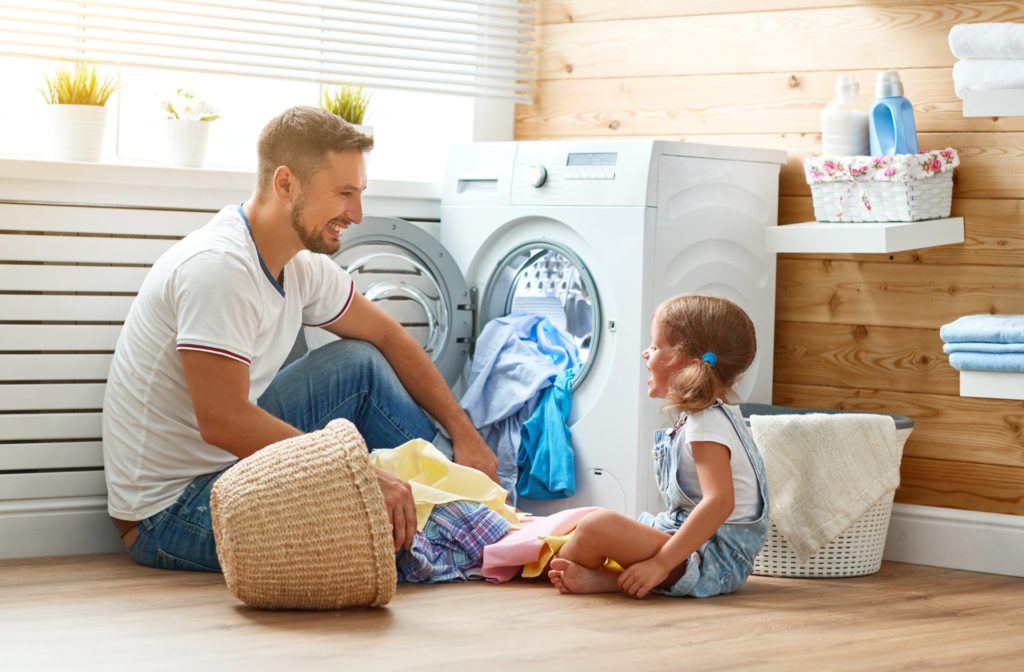 Dan and daughter washing clothes