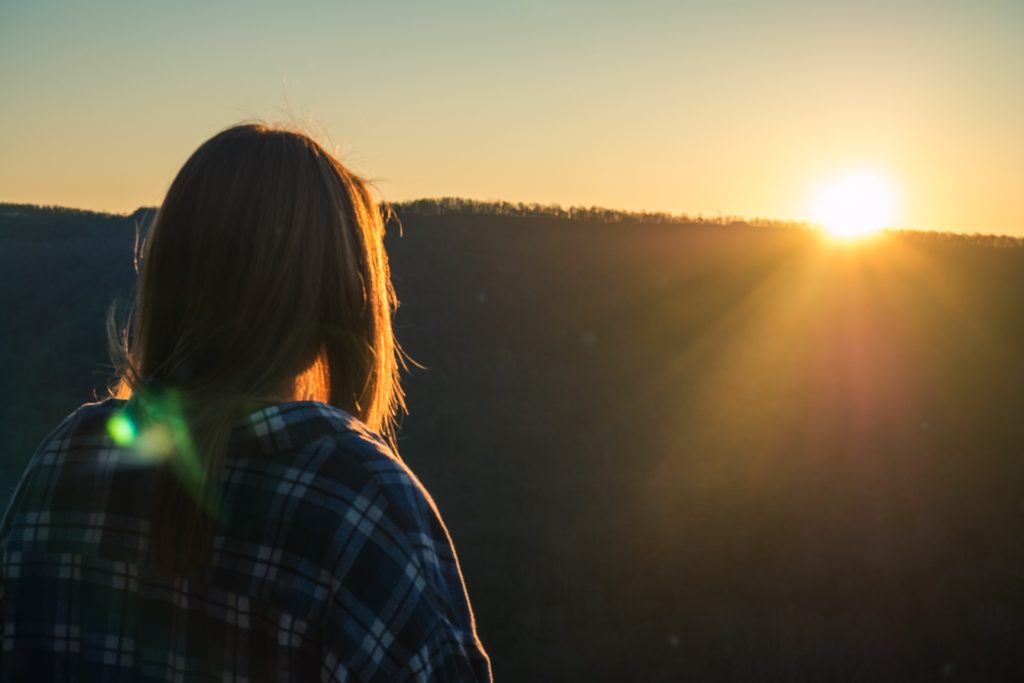 Woman looking unto the sunny horizon