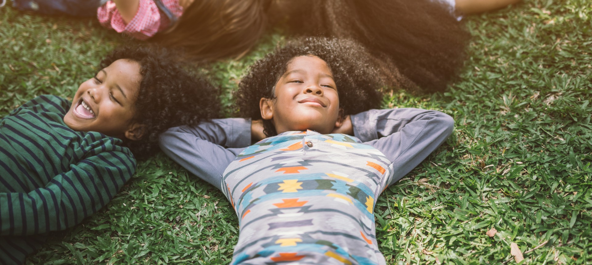 Kids playing in the grass and enjoying the outdoors